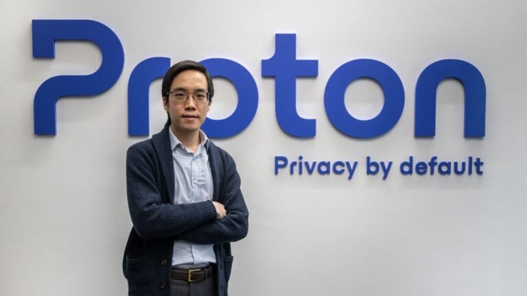 Proton CEO and founder Andy Yen poses next to the Proton logo at the headquarters of the encrypted email and VPN services company in Geneva.